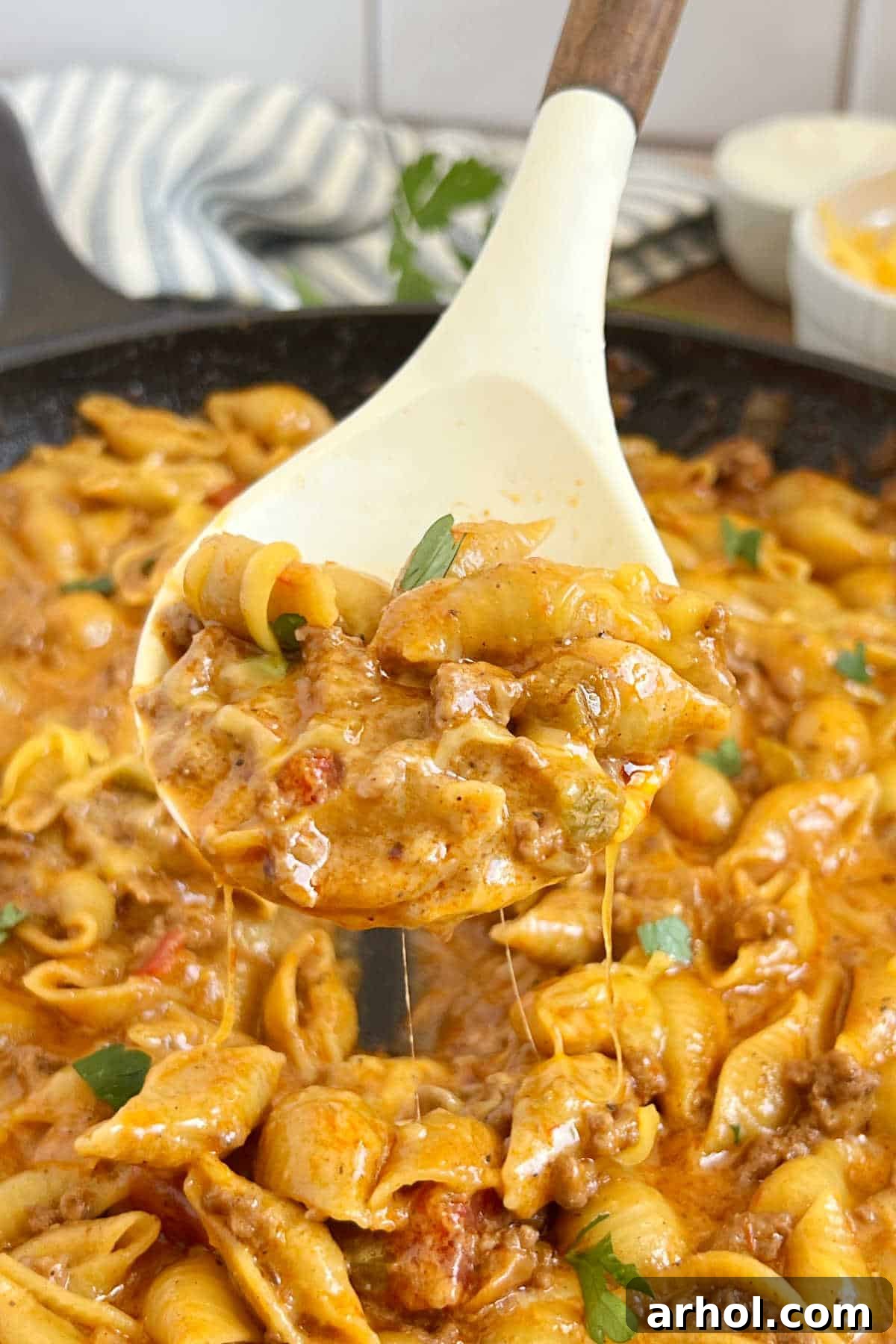 Quick One-Pot Cheesy Taco Pasta 2 Creamy, cheesy taco pasta served on a spoon, ready to be enjoyed.