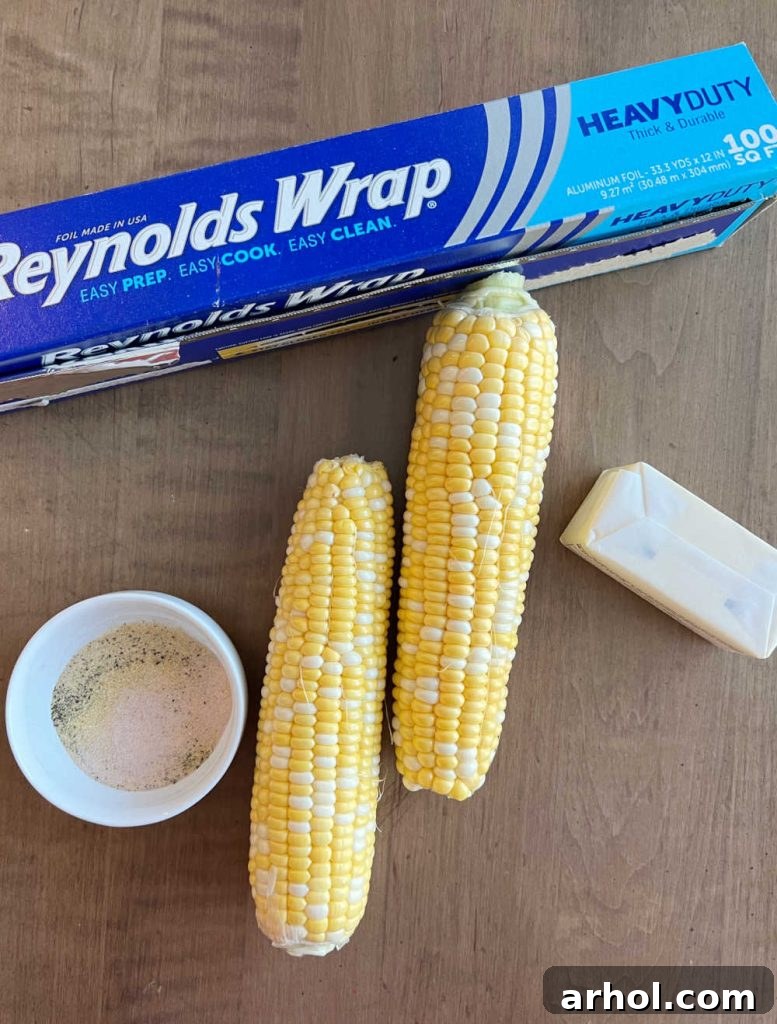 Fresh corn on the cob, aluminum foil, butter and salt, pepper and garlic powder