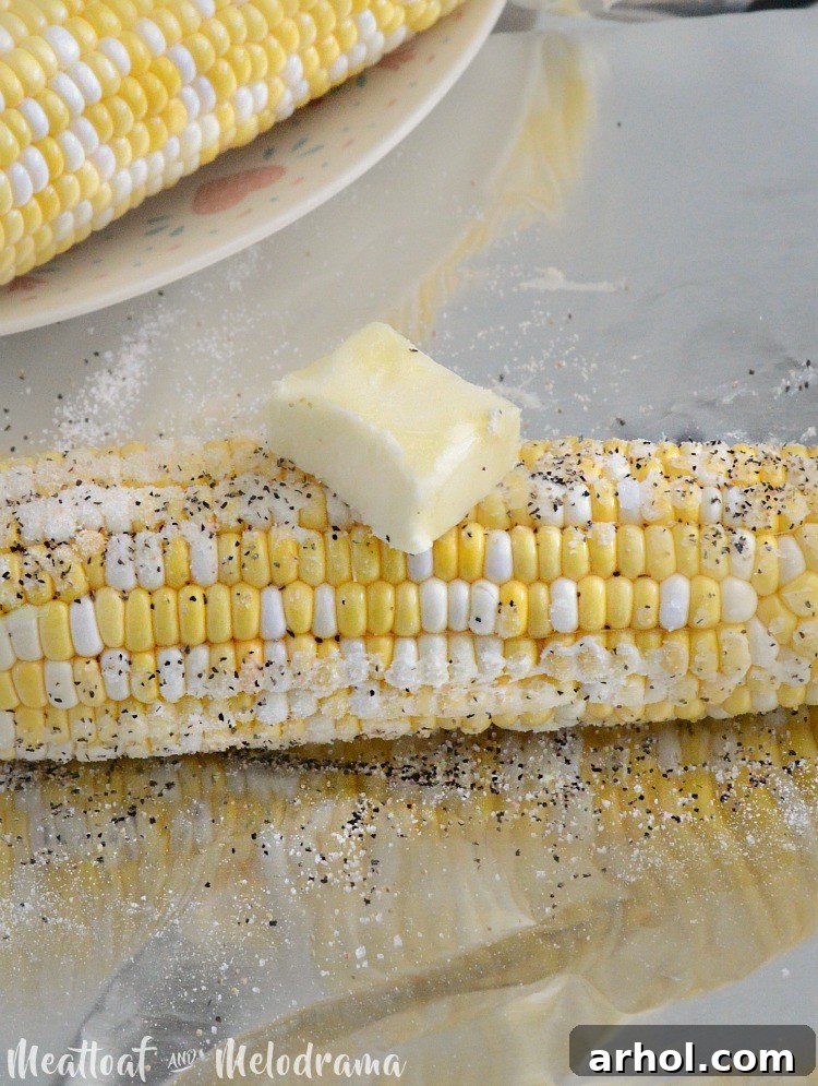 Butter, salt, and pepper on fresh corn wrapped in aluminum foil