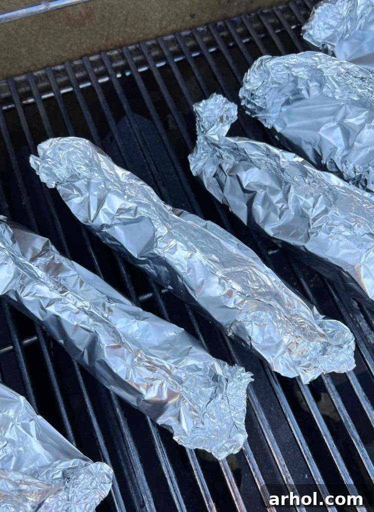 Corn on the cob in foil packets on grill