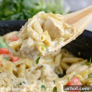 Creamy One Pot Salsa Verde Chicken Pasta on a wooden spoon