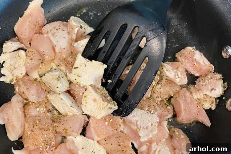 cubed chicken breasts in non stick skillet