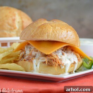 Crock-Pot Honey Buffalo Chicken Sliders with ranch dressing and celery sticks