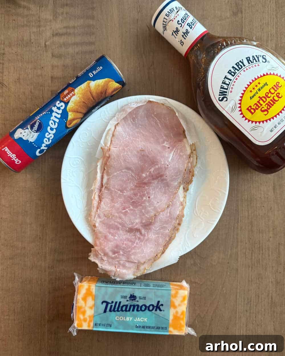 Crispy Ham & Cheese Crescents 3 Key ingredients for ham and cheese crescent rolls: sliced ham, crescent roll dough, barbecue sauce, and shredded cheese.
