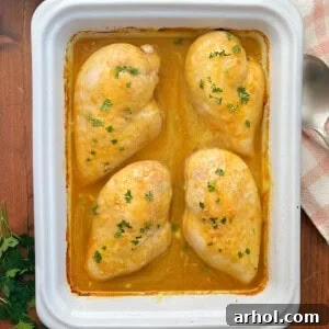 Honey mustard curry chicken with parsley in baking dish.
