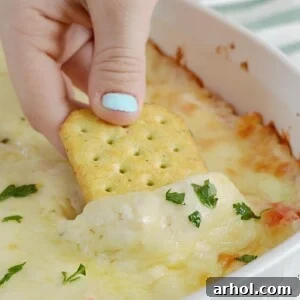 cheesy hot crab dip with melted cheese on cracker