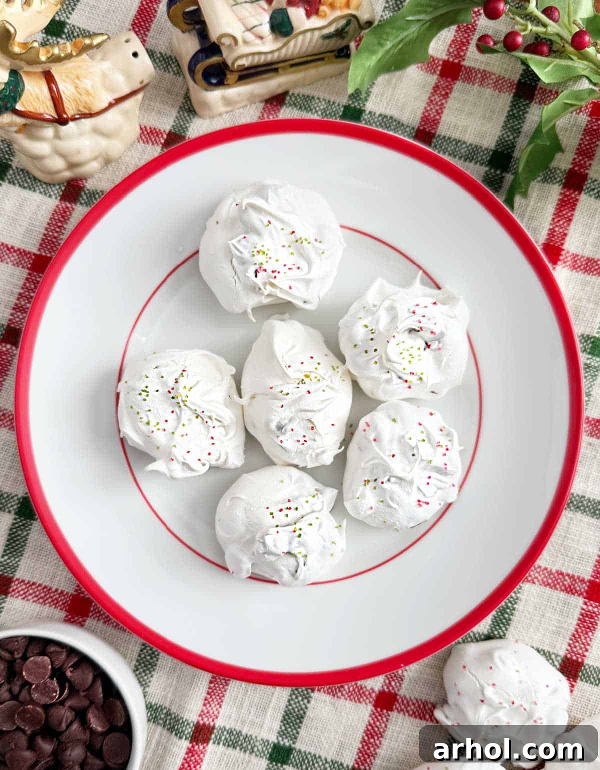 meringue chocolate chip cookies on a red and white plate.