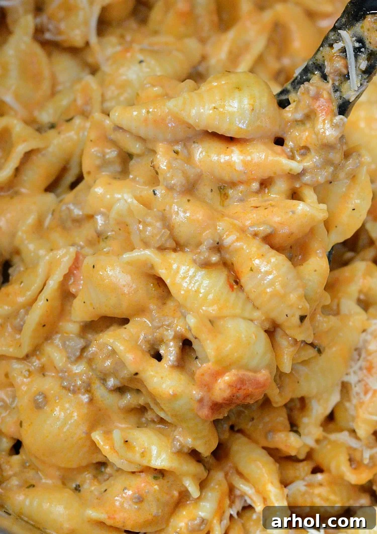 The Instant Pot Creamy Shells and Beef after cooking, stirring in cream and cheese.