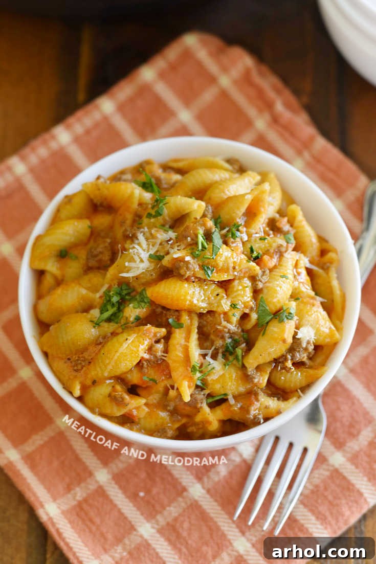 A large serving bowl filled with Instant Pot Creamy Shells and Beef, ready to be dished out.