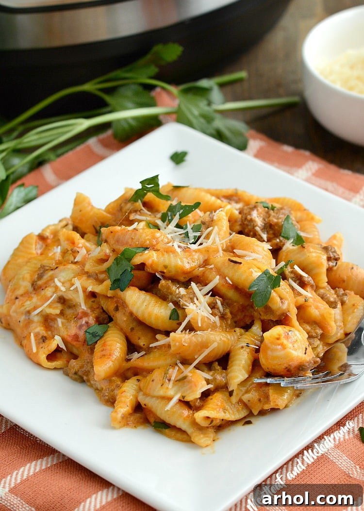 A close-up of Instant Pot Creamy Shells and Beef on a plate, garnished with fresh parsley.