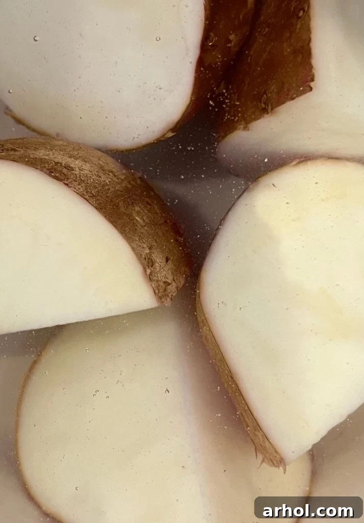 Boiling potatoes with skins on in a large pot