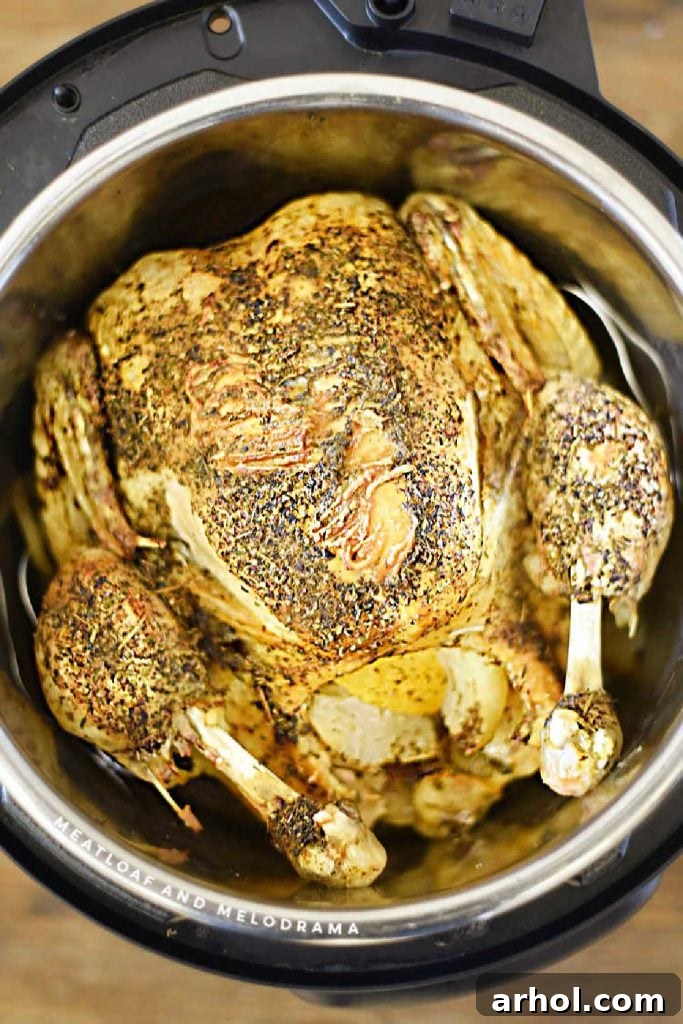 Juicy Instant Pot Whole Chicken 2 Instant Pot Whole Roast Chicken cooked to perfection with crispy golden skin, ready to be carved and served for a delicious family meal