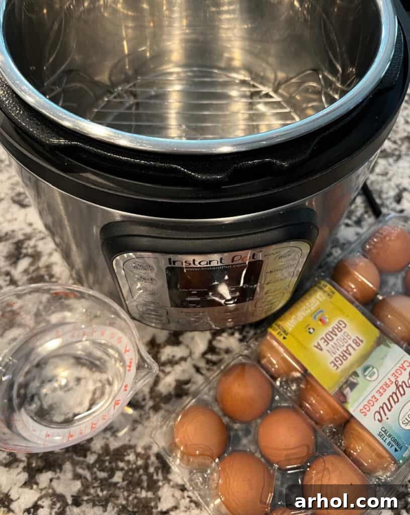 Raw eggs, water, and an Instant Pot pressure cooker on a kitchen counter.