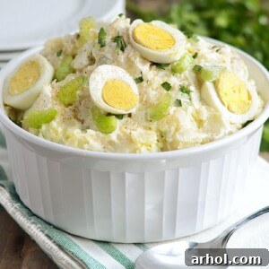 Instant Pot potato salad with red potatoes in a bowl, garnished with hard-cooked eggs and celery
