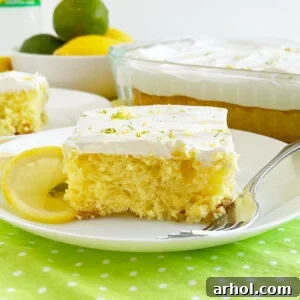 Slice of Sprite cake (lemon lime soda cake) with Cool Whip frosting on a plate