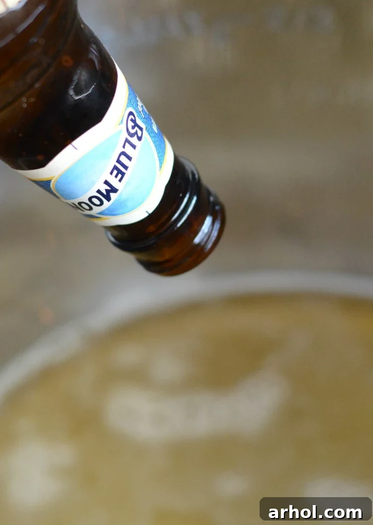 Pouring beer into an Instant Pot with a trivet for cooking ribs