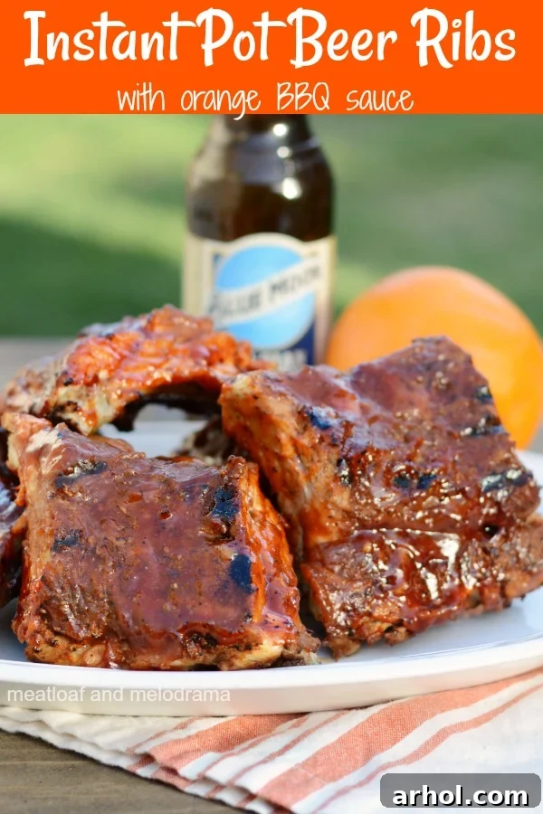 Close-up of Instant Pot Beer Ribs with a rich orange BBQ sauce on a platter