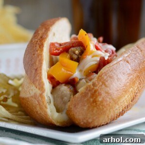 instant pot sausage and peppers with cheese on sandwich buns on plate