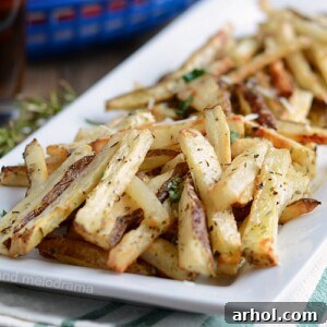 homemade baked french fries with rosemary on white platter