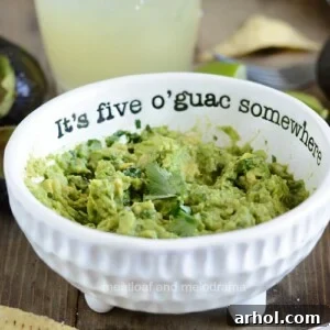Simple Guacamole Recipe served in a white bowl with the phrase 'It's 5 o'guac somewhere'