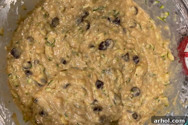 Moist zucchini banana muffin batter with generous amounts of semi-sweet chocolate chips folded in.