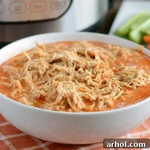 instant pot buffalo chicken recipe shredded in white bowl
