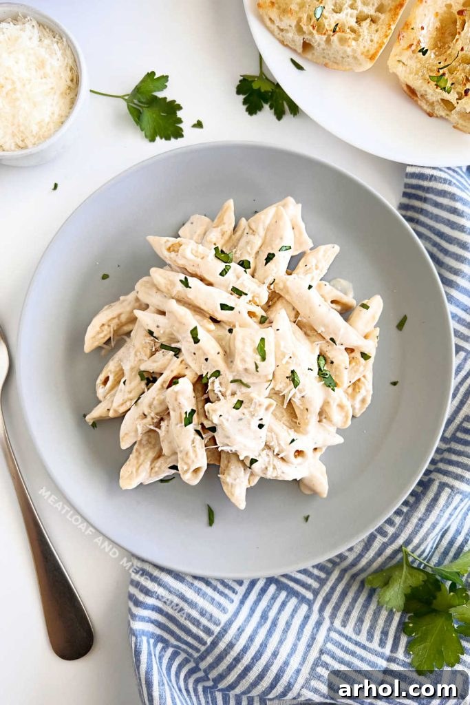 Instant Pot chicken Alfredo penne pasta on a dinner table, ready to serve