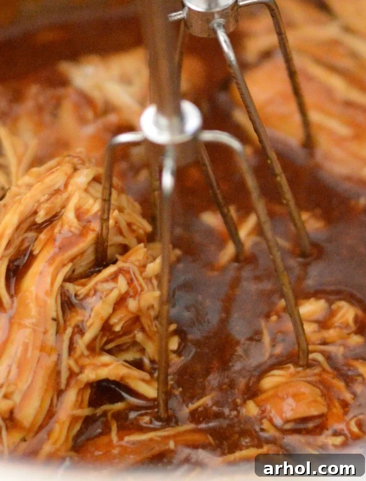 Shredding tender BBQ chicken directly in the Instant Pot with an electric hand mixer