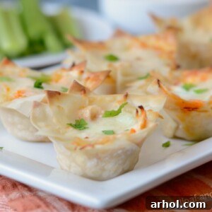 Instant Pot Buffalo Chicken Poppers 2 instant pot buffalo chicken cups made with wonton wrappers and chicken dip on plate