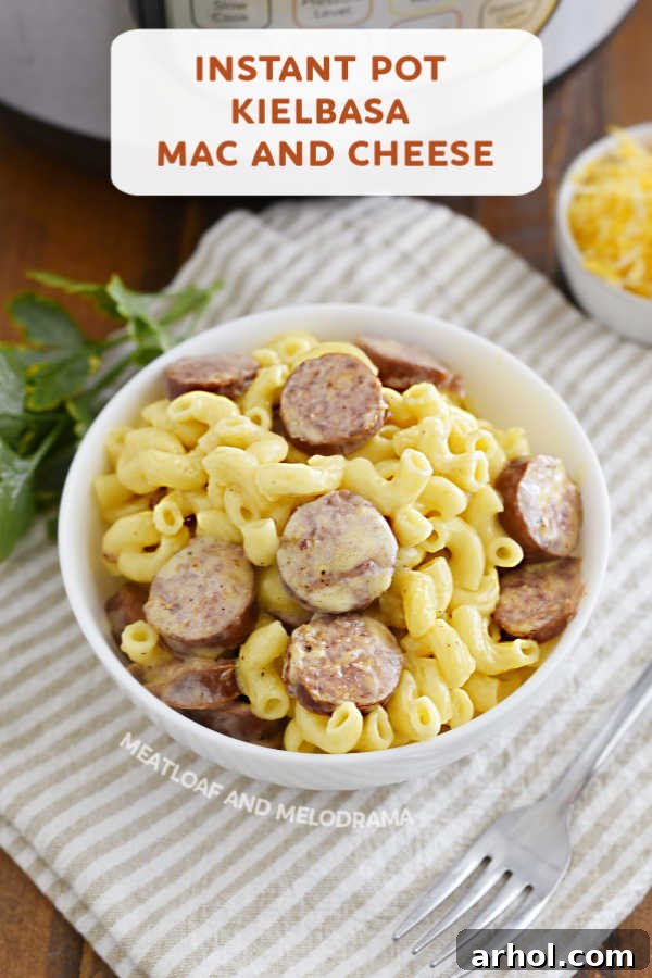 Close-up of a serving of Instant Pot Kielbasa Mac and Cheese in a bowl, showing the creamy texture and sausage slices.