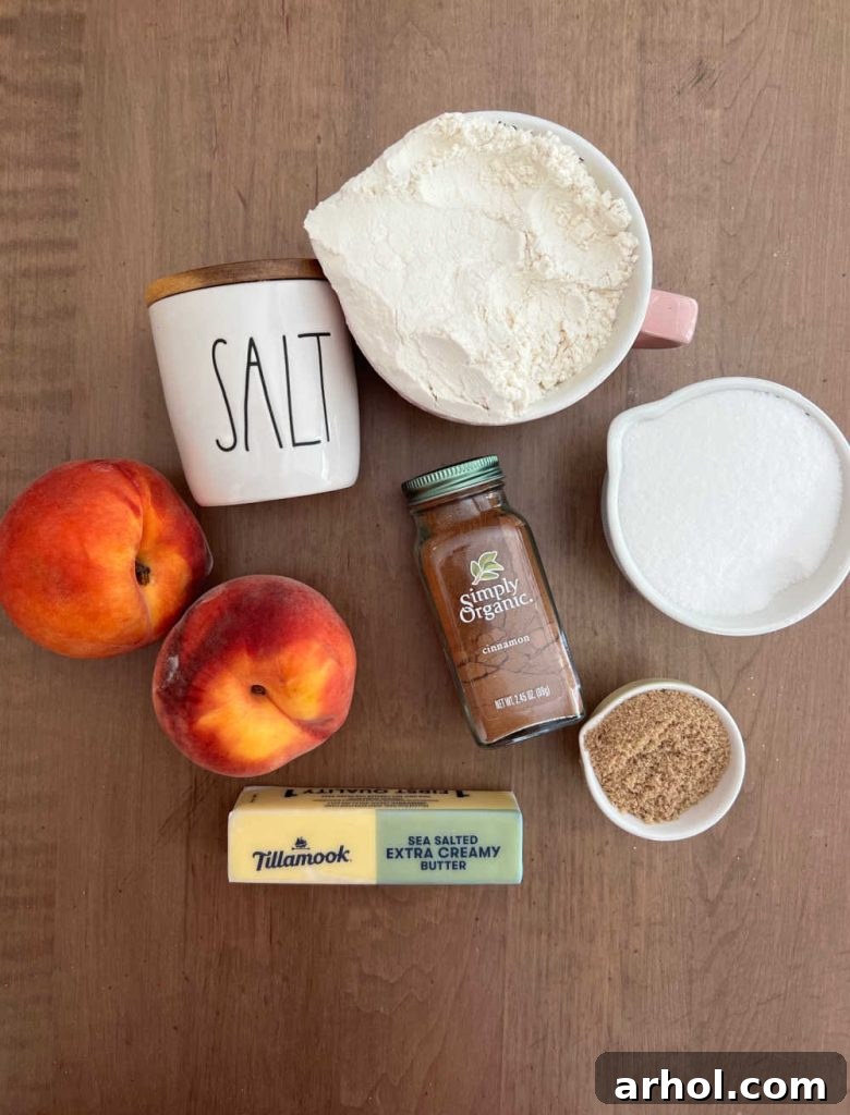 Summertime Peach Crisp Delight 3 Ingredients for a fresh peach crisp without oats, including ripe peaches, flour, butter, brown sugar, granulated sugar, salt, and cinnamon, neatly arranged.