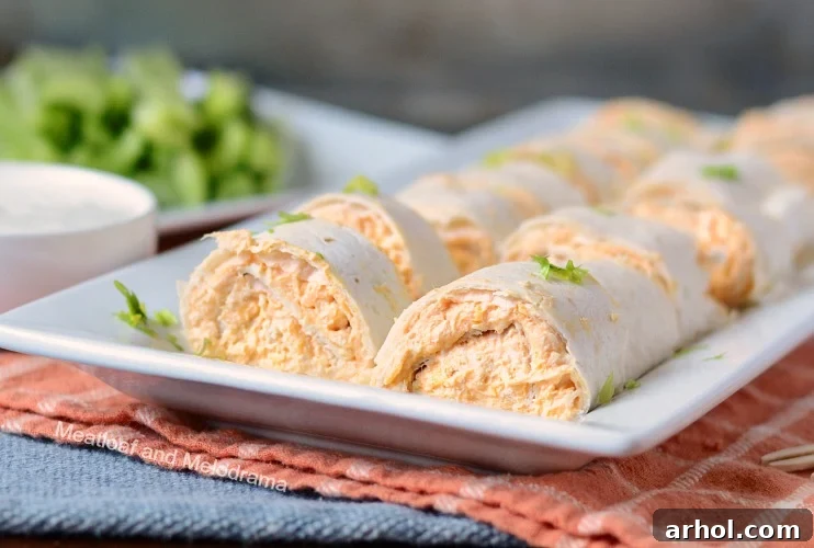 Instant Pot Buffalo chicken roll-ups arranged neatly on a white platter, ready to be served as an appetizer.