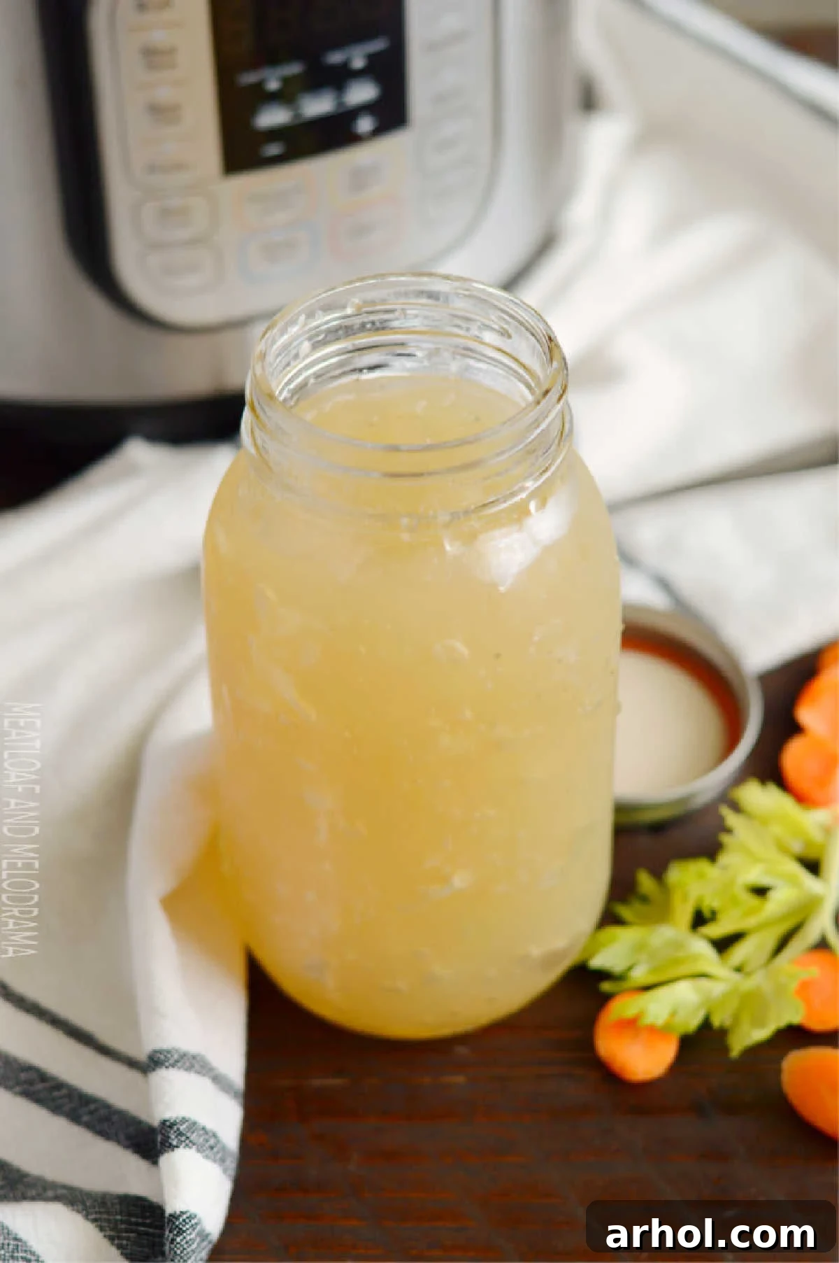 Instant Pot Turkey Stock or Turkey Bone Broth in a mason jar, garnished with fresh herbs