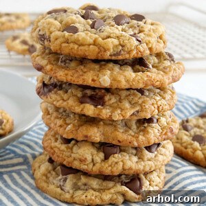 Best oatmeal chocolate chip cookies stacked on a wooden table, ready to be served.