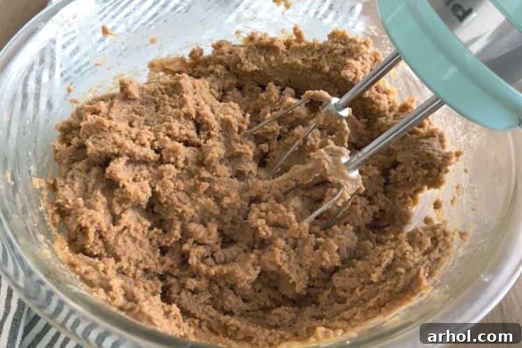 The Easiest 4 Ingredient Peanut Butter Cookies 3 Thick, rich flourless peanut butter cookie dough in a mixing bowl, ready for shaping.