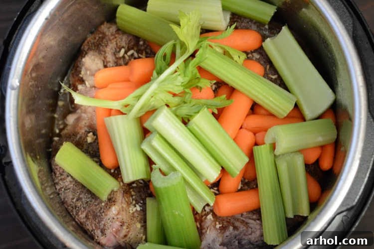 Tender Instant Pot Pot Roast 5 add carrots and celery over chuck roast in instant pot