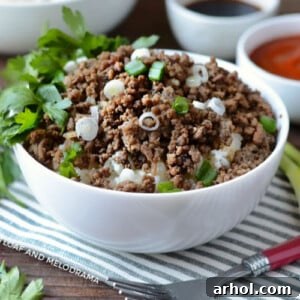 Instant Pot Korean Ground Beef topped with fresh scallions over rice in a white bowl, ready to serve