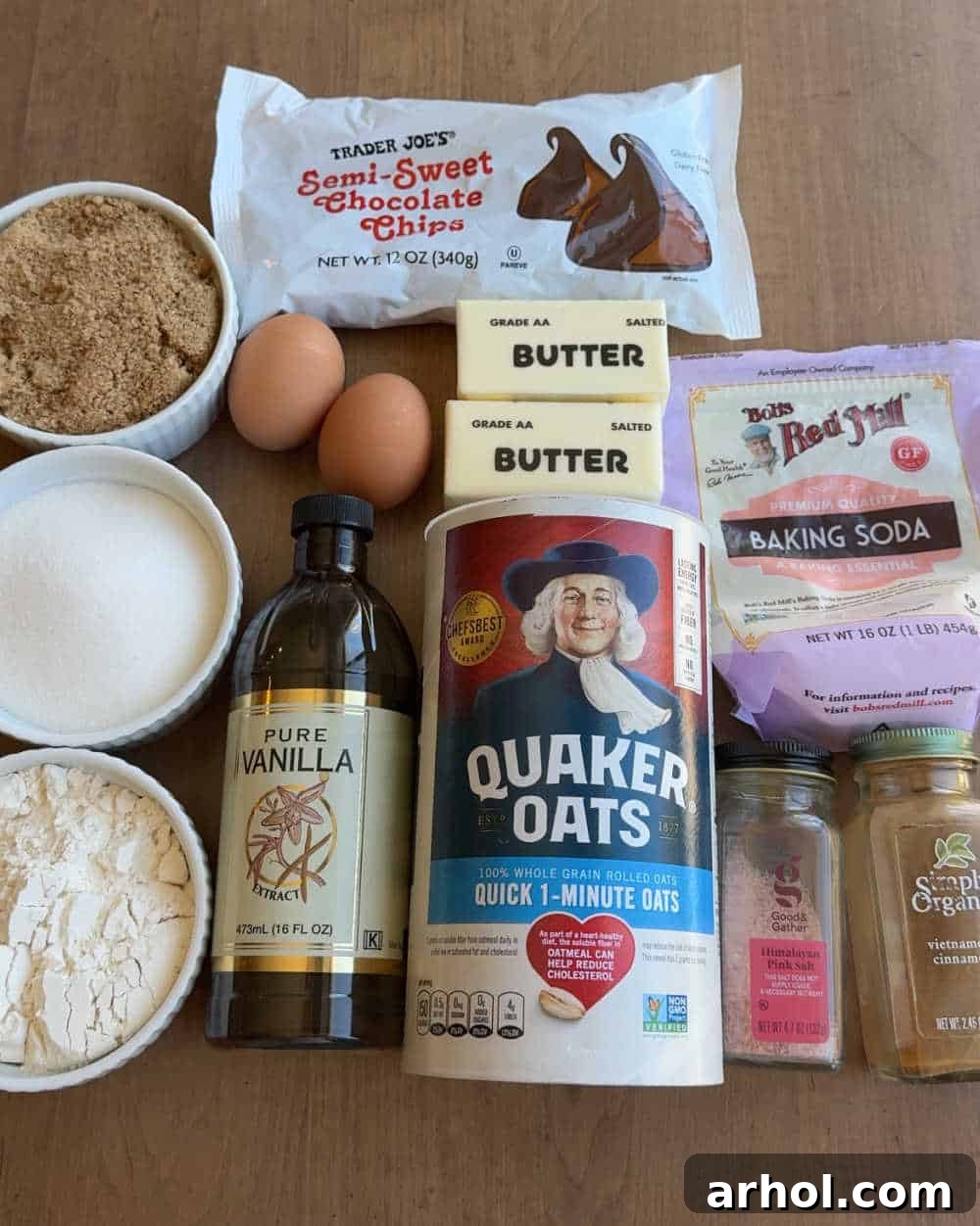 Essential ingredients for baking oatmeal chocolate chip bars: oats, flour, sugars, butter, eggs, and chocolate chips.