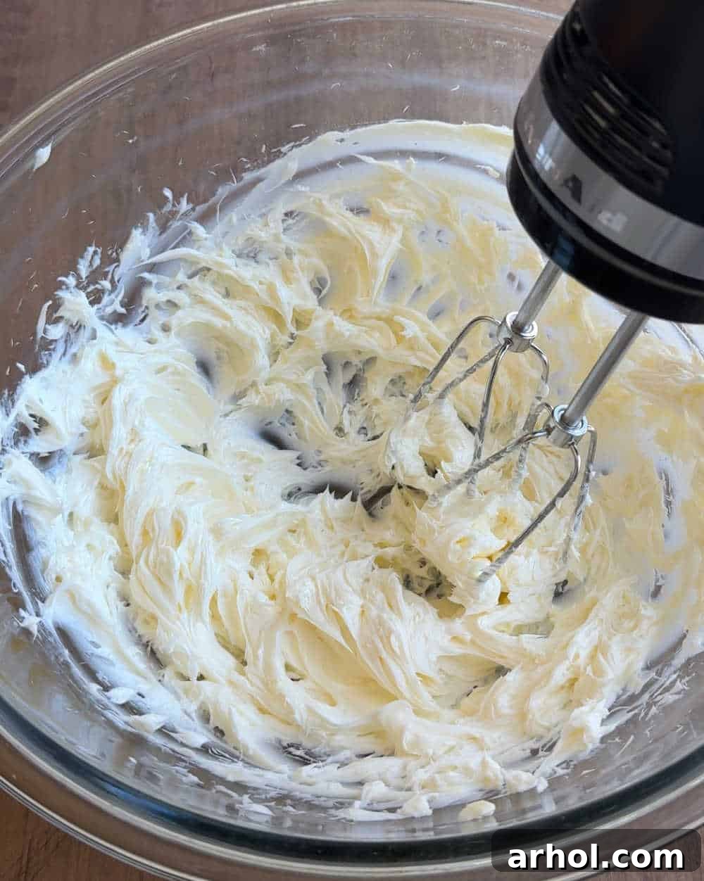 Creaming butter in a mixing bowl with an electric mixer.