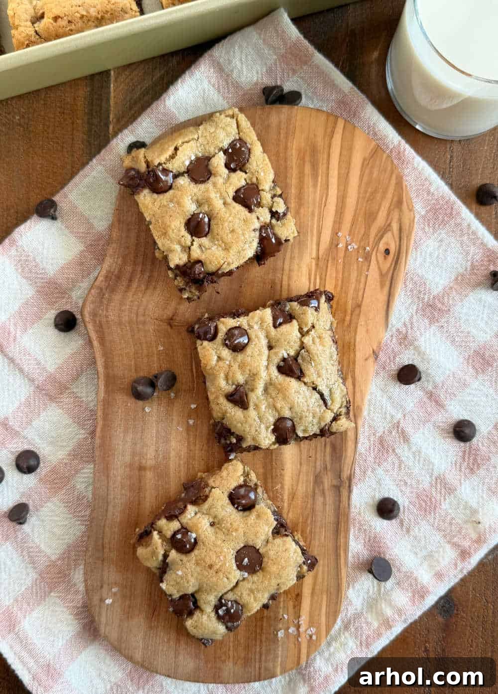 Freshly sliced oatmeal chocolate chip bars with a glass of milk, ready to be enjoyed.