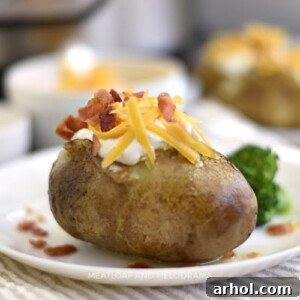 instant pot baked potatoes with sour cream cheddar cheese and bacon on a plate