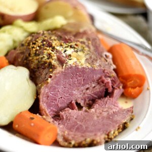 Instant Pot corned beef and cabbage with carrots and red potatoes on white platter