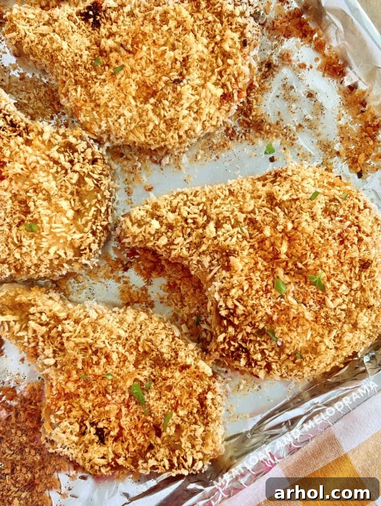 crispy panko breaded pork chops baked in oven on baking sheet
