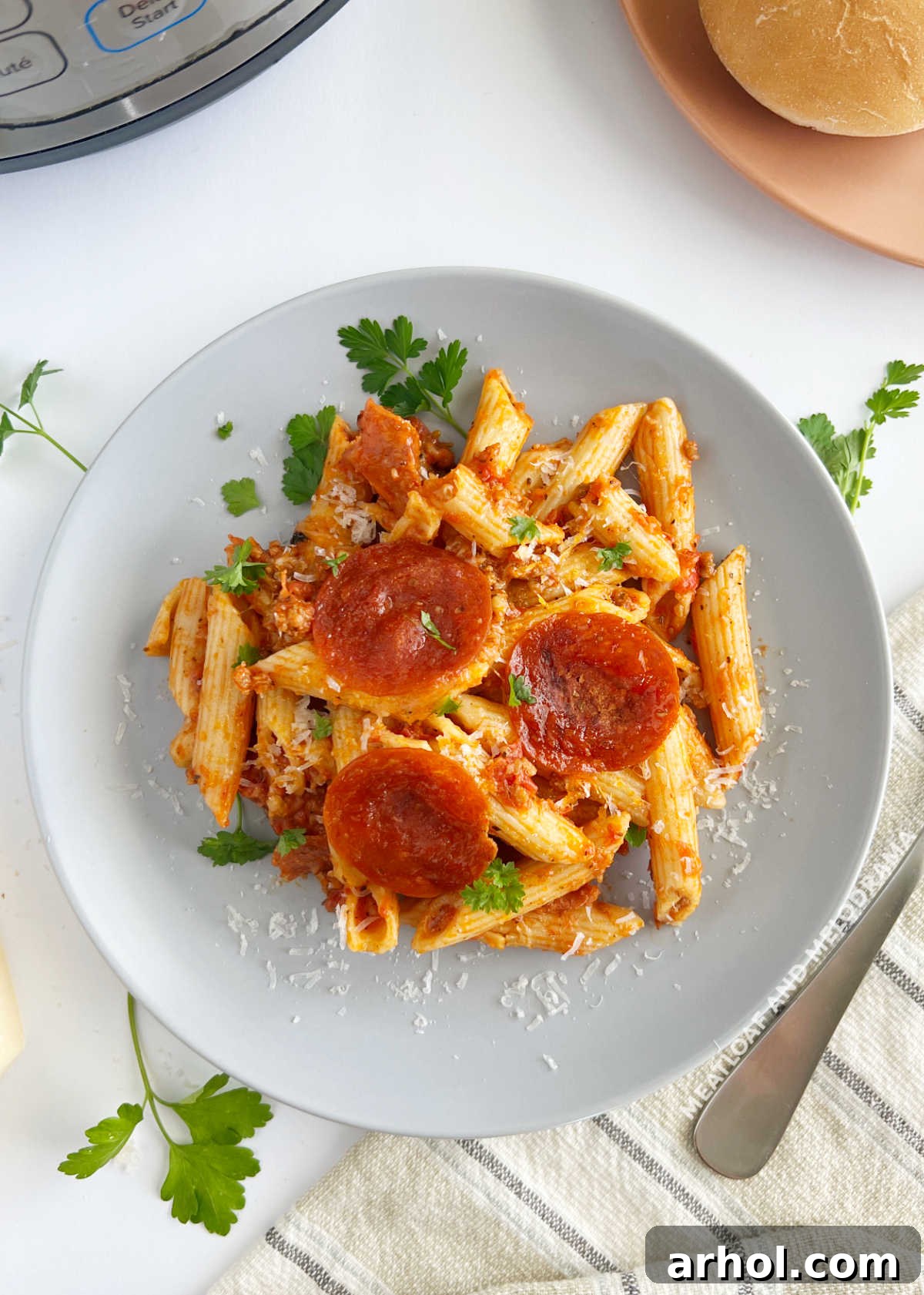 plate of instant pot pizza pasta with penne and pepperoni slices on the table