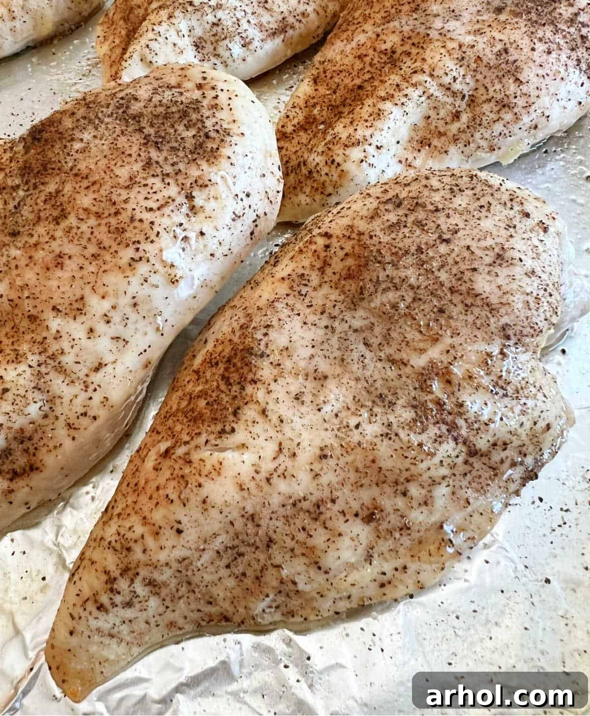 Perfectly seasoned and golden-brown baked chicken breasts, ready for slicing or serving.