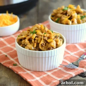 instant pot bbq macaroni and beef with cheddar cheese in white bowls