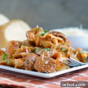 instant pot creamy sausage tortellini with basil on plate