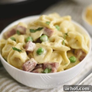 instant pot ham and cheese tortellini with peas in a white bowl