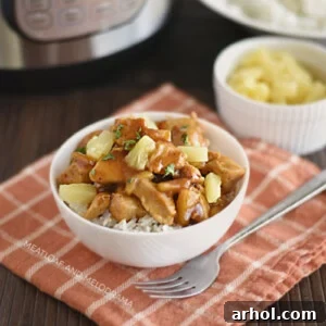 Instant Pot Hawaiian BBQ Chicken over rice in a bowl with pineapples