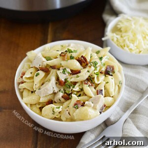 A bowl of Instant Pot Creamy Chicken Bacon Ranch Pasta, garnished with fresh parsley.